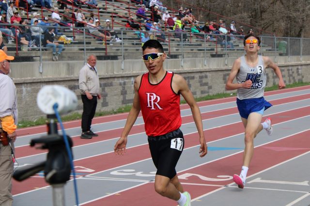two students running at track meet
