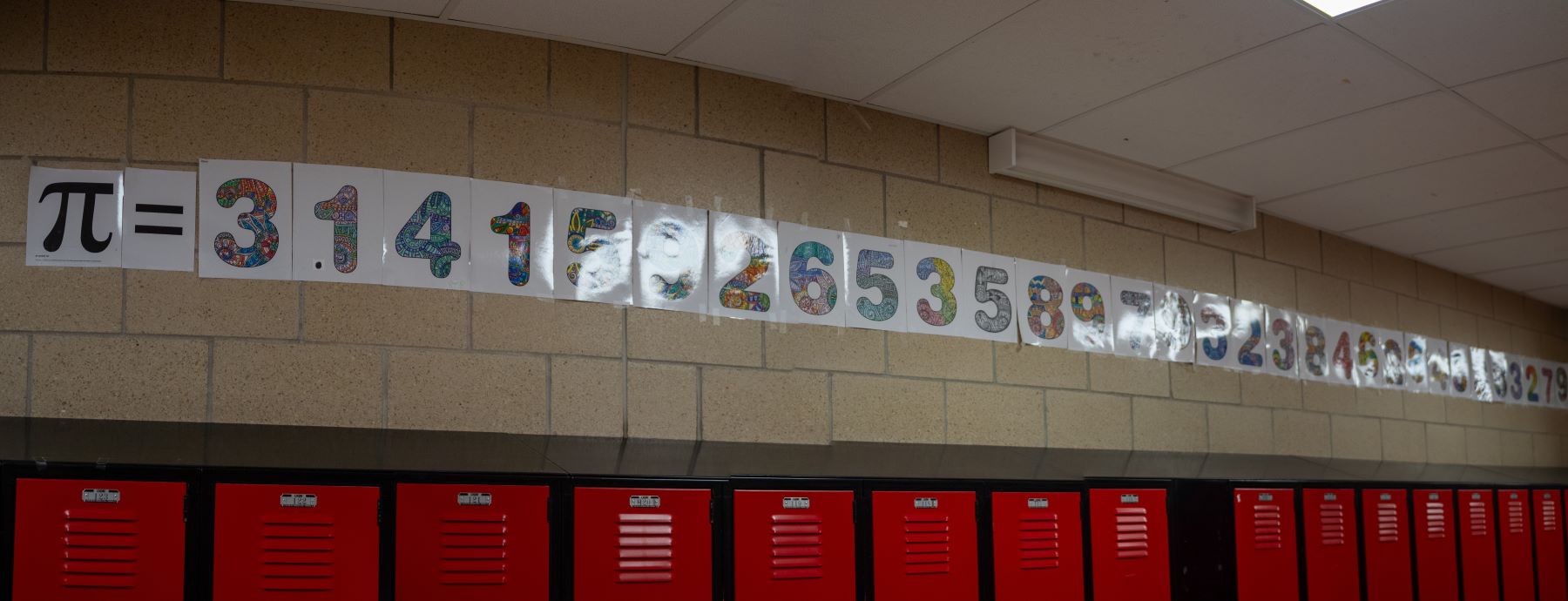 A wall covered in numbers and the symbol for pi, showcasing mathematical concepts in a creative display.